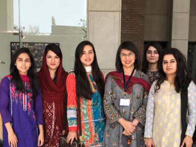 Dr. Shaper and her Biology team standing in front of the SBASSE building